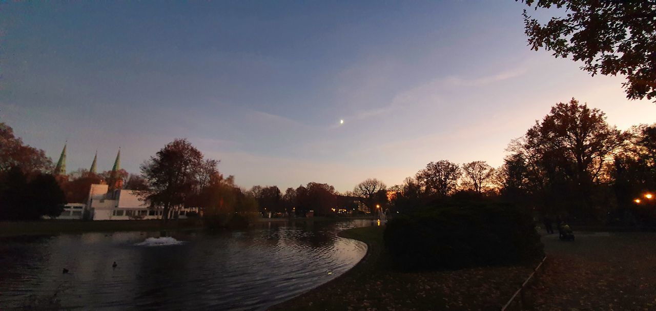 SCENIC VIEW OF PARK AGAINST SKY DURING SUNSET