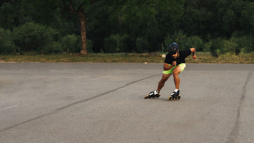 Full length of man inline skating on road