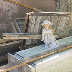 A beautiful collectible doll in the trash heap.  abandoned beauty.
