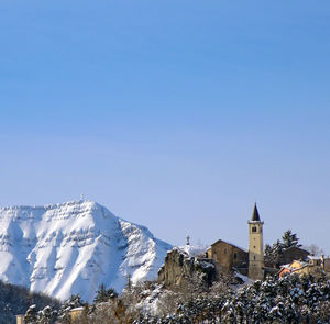 Scenic view of buildings against clear blue sky