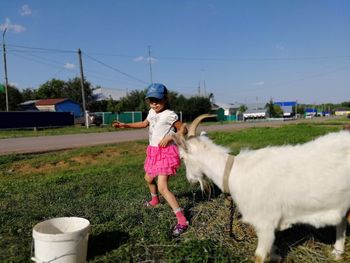 Full length of man standing on grass against sky