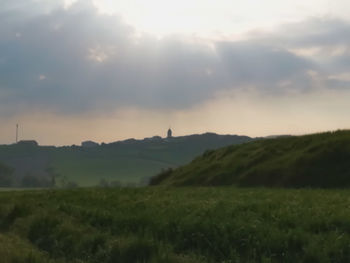 Scenic view of field against sky during sunset