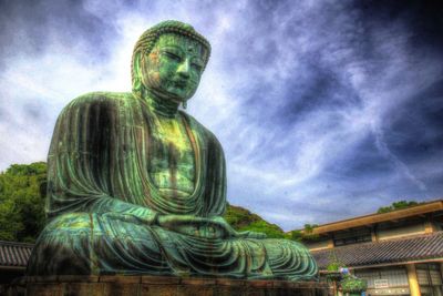Low angle view of statue against cloudy sky