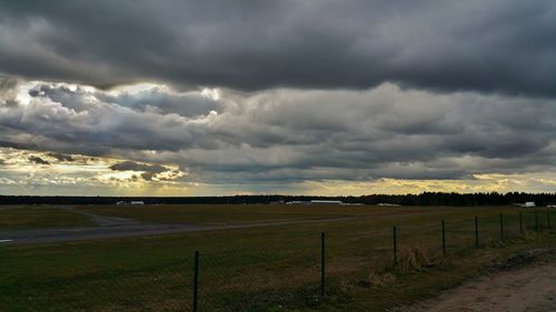 Scenic view of landscape against cloudy sky