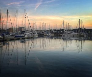 Boats in harbor at sunset
