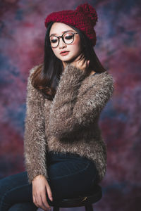 Young woman wearing hat looking away during winter