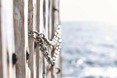 Close-up of padlock on wooden post