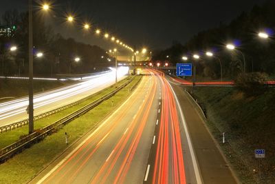 High angle view of light trails on highway at night