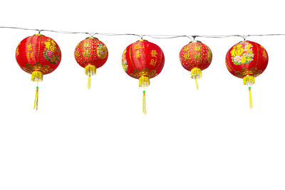 Low angle view of lanterns hanging against clear sky