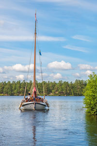 Sailboat in river against sky