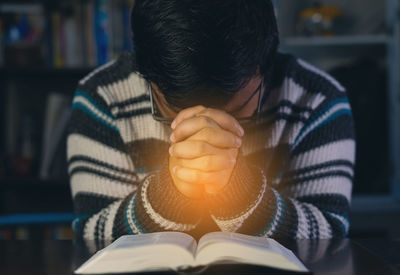 Midsection of man holding book