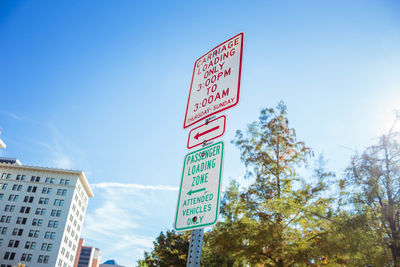 Low angle view of road sign against sky