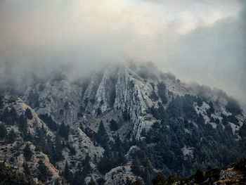 High angle view of rocky mountains in foggy weather