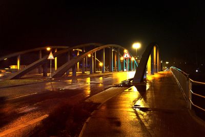 Illuminated bridge at night