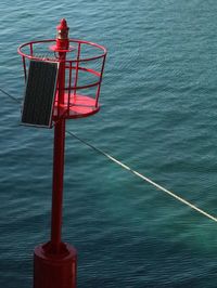 High angle view of red floating buoy in sea