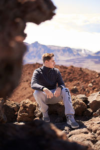 Full length of young man on rock