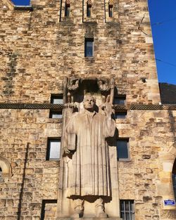 Low angle view of statue against building