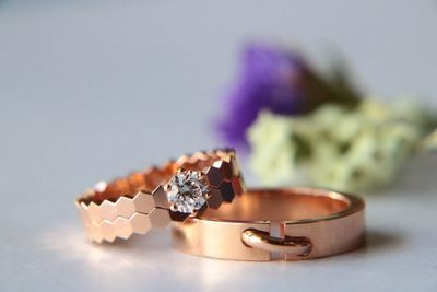 Close-up of wedding rings on table