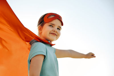 Portrait of smiling boy against clear sky