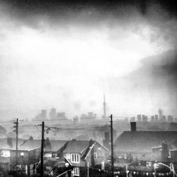 Cityscape against cloudy sky