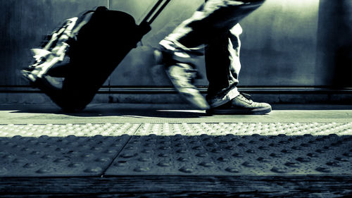 Low section of man walking on floor