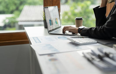 Midsection of business colleagues working on table
