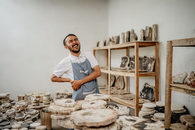 Side view of young man making food at home