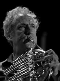 Close-up of man playing french horn