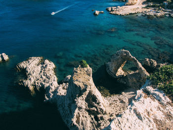 High angle view of rocks in sea