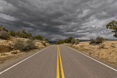 Empty road along countryside landscape