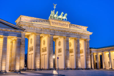 The famous illuminated brandenburg gate in berlin during blue hour