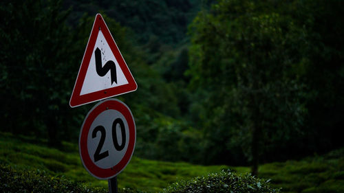 Road sign by trees