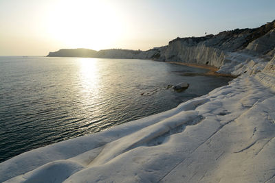 Scenic view of sea against clear sky during sunset