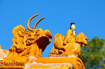 Low angle view of statue against sky