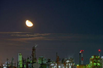 Illuminated cityscape against sky at night