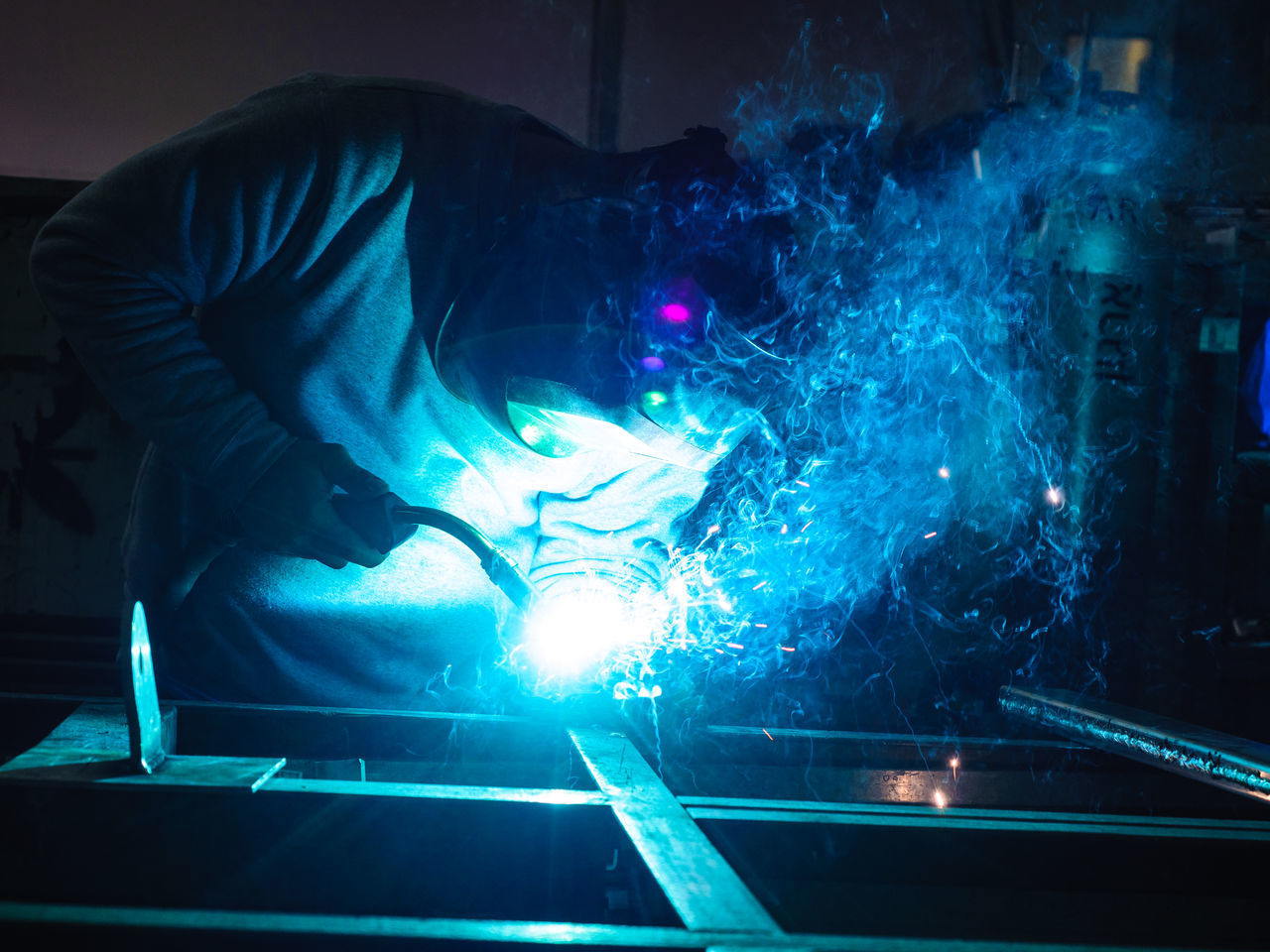 MAN WORKING AT ILLUMINATED LIGHT