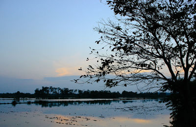 Scenic view of lake against sky during sunset