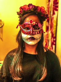 Portrait of teenage girl wearing mask at home