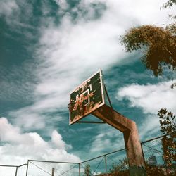 Low angle view of information sign against sky