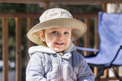 Portrait of young woman wearing hat standing outdoors