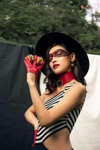Portrait of beautiful woman standing against wall