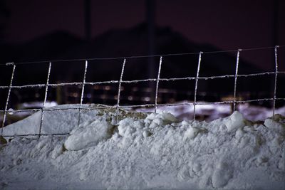 Close-up of frozen water on fence