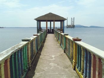 Lifeguard hut on beach against sky