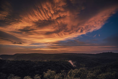 Scenic view of dramatic sky over landscape