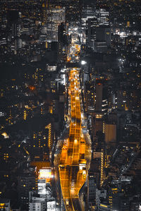 High angle view of city lit up at night