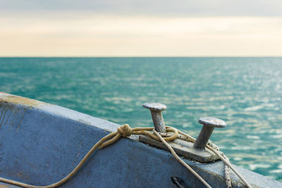 Rope on boat in sea against sky