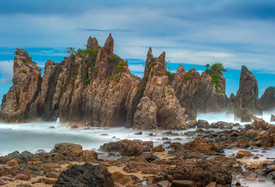 Rocks on beach against sky