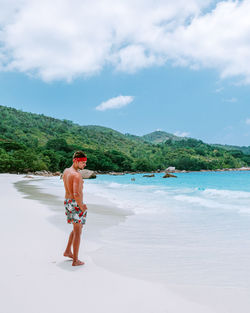 Full length of man on beach against sky