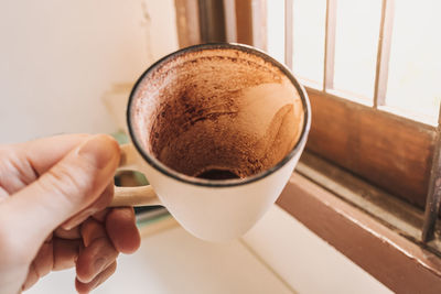 Hand holding coffee cup