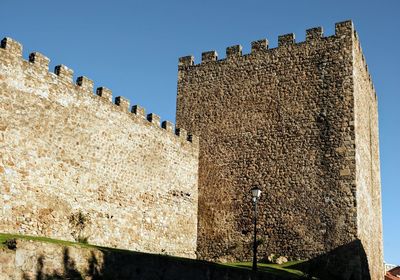 Low angle view of fort against clear blue sky